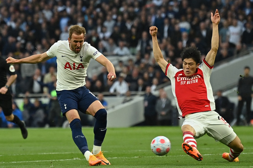 Tottenham Hotspur's English striker Harry Kane (L) vies with Arsenal's Japanese defender Takehiro Tomiyasu (R) during the English Premier League football match between Tottenham Hotspur and Arsenal at Tottenham Hotspur Stadium in London, on May 12, 2022. (Photo by GLYN KIRK/AFP via Getty Images)