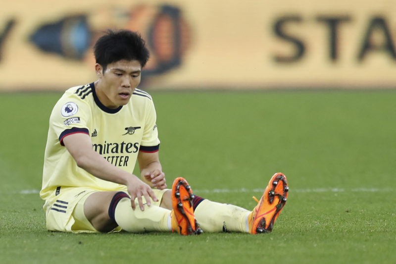 Arsenal's Japanese defender Takehiro Tomiyasu reacts on the pitch after being tackled during the English Premier League football match between West Ham United and Arsenal at the London Stadium, in London on May 1, 2022. (Photo by IAN KINGTON/IKIMAGES/AFP via Getty Images)