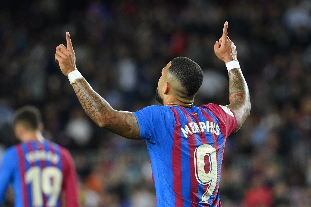 Barcelona's Dutch forward Memphis Depay celebrates after scoring a goal during the Spanish league football match between FC Barcelona and RC Celta de Vigo at the Camp Nou stadium in Barcelona on May 10, 2022. (Photo by LLUIS GENE/AFP via Getty Images)