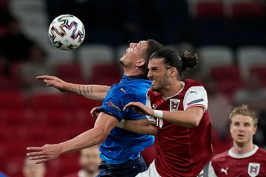 Austria's midfielder Florian Grillitsch (C) vies for the ball with Italy's forward Andrea Belotti (L) during the UEFA EURO 2020 round of 16 football match between Italy and Austria at Wembley Stadium in London on June 26, 2021. (Photo by FRANK AUGSTEIN/POOL/AFP via Getty Images)