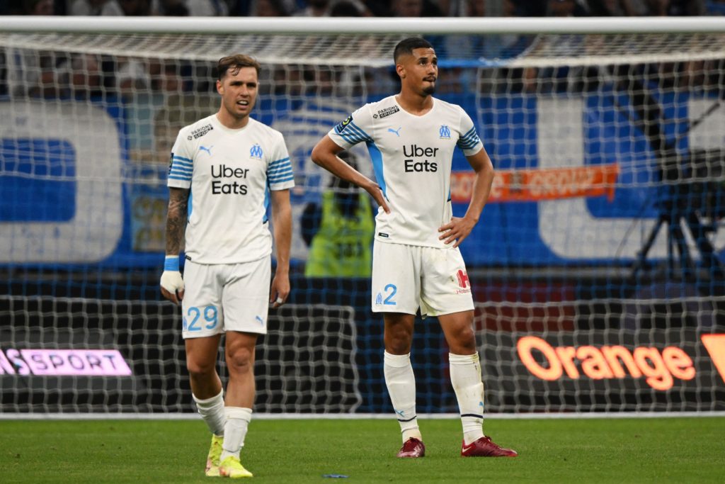 Marseille's Spanish defender Pol Lirola (L) and Marseille's French defender William Saliba react during the French L1 football match between Olympique Marseille (OM) and Olympique Lyonnais at Stade Velodrome in Marseille, southern France, on May 1, 2022. (Photo by NICOLAS TUCAT/AFP via Getty Images)