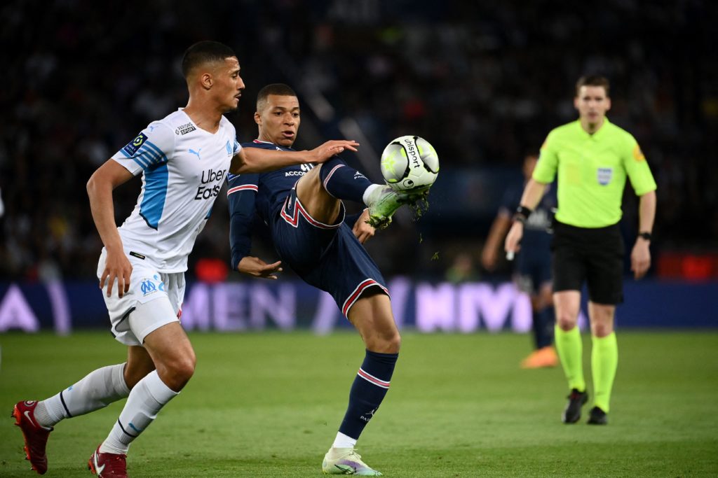 Marseille's French defender William Saliba (L) fights for the ball with Paris Saint-Germain's French forward Kylian Mbappe during the French L1 football match between Paris-Saint Germain (PSG) and Olympique Marseille (OM) at The Parc des Princes Stadium in Paris on April 17, 2022. (Photo by FRANCK FIFE/AFP via Getty Images)