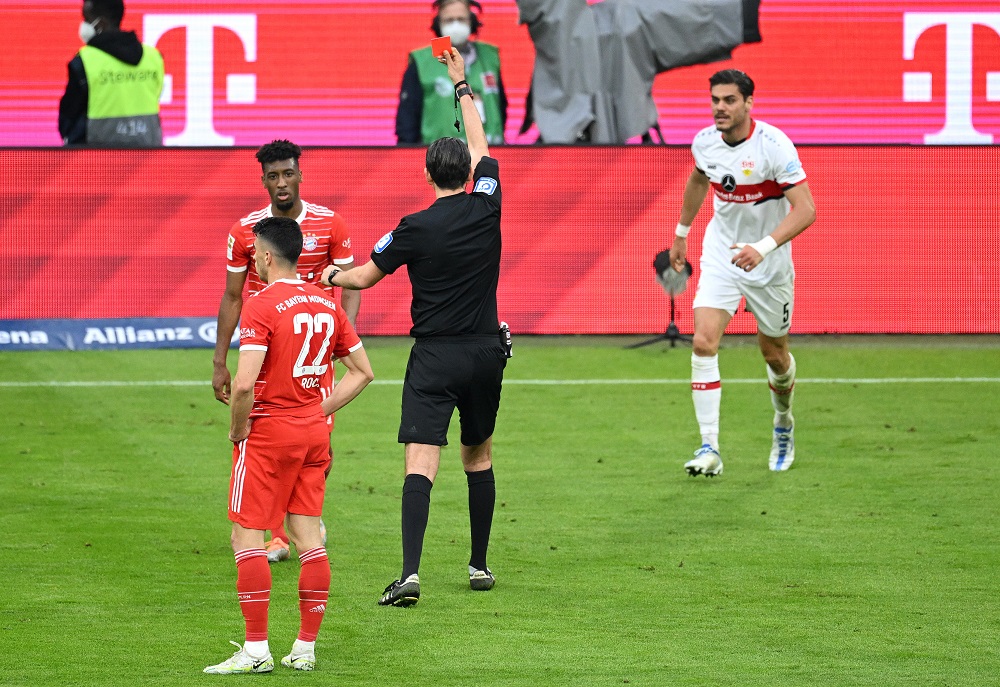 MUNICH, GERMANY: Kingsley Coman of FC Bayern Muenchen is shown a red card by referee Deniz Aytekin during the Bundesliga match between FC Bayern München and VfB Stuttgart at Allianz Arena on May 08, 2022. (Photo by Matthias Hangst/Getty Images)