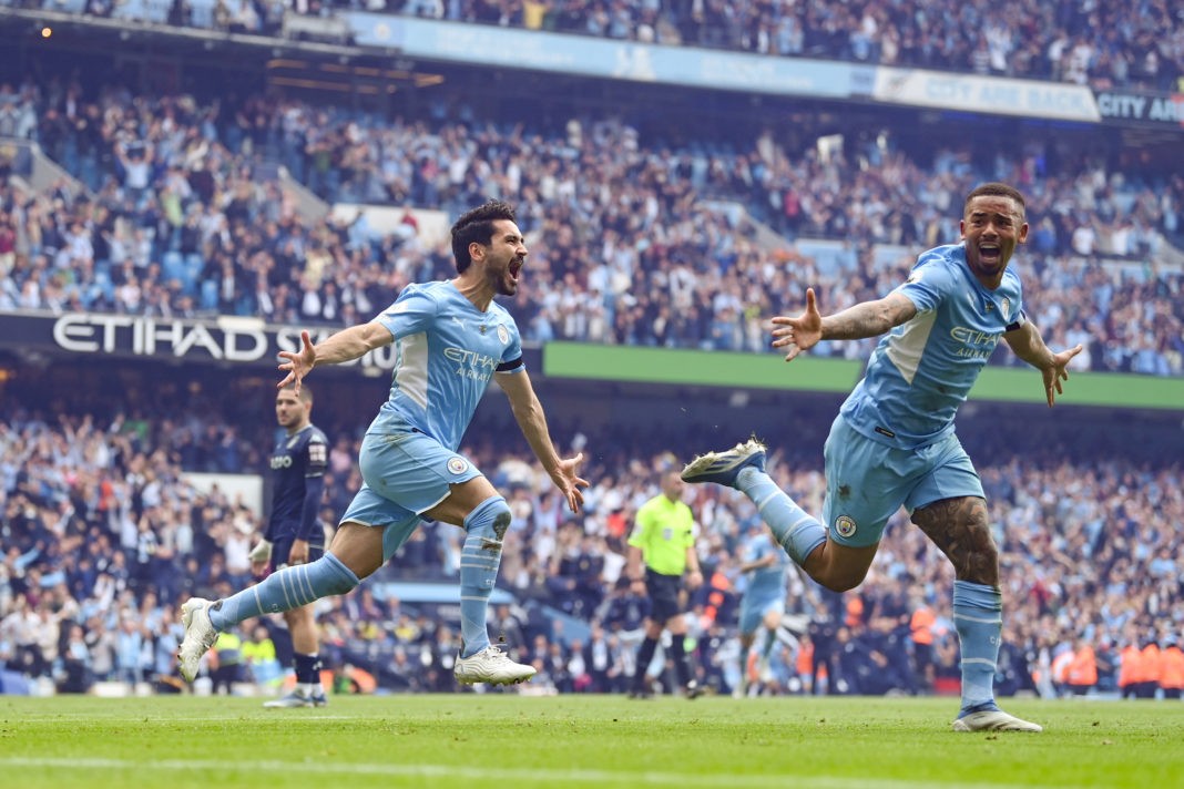 MANCHESTER, ENGLAND: Ilkay Guendogan of Manchester City celebrates after scoring their team's third goal with Gabriel Jesus during the Premier League match between Manchester City and Aston Villa at Etihad Stadium on May 22, 2022. (Photo by Michael Regan/Getty Images)