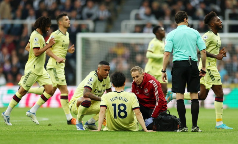 NEWCASTLE UPON TYNE, ENGLAND - MAY 16: Takehiro Tomiyasu of Arsenal receives medical treatment during the Premier League match between Newcastle United and Arsenal at St. James Park on May 16, 2022 in Newcastle upon Tyne, England. (Photo by Ian MacNicol/Getty Images)