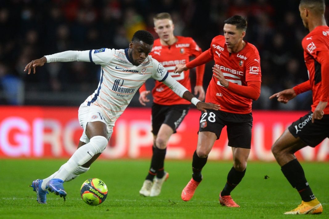 Montpellier's English forward Stephy Mavididi (L) fights for the ball with Rennes' French midfielder Jonas Martin (R) during the French L1 football match between Stade Rennais Football Club and Montpellier Herault SC, at The Roazhon Park Stadium in Rennes, north-western France on November 20, 2021. (Photo by JEAN-FRANCOIS MONIER/AFP via Getty Images)