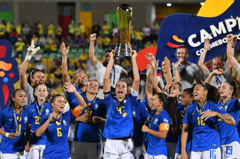 BUCARAMANGA, COLOMBIA - JULY 30: Rafaelle of Brazil lifts the trophy with teammates after winning the final match between Brazil and Colombia as part of Women's CONMEBOL Copa America 2022 at Estadio Alfonso Lopez on July 30, 2022 in Bucaramanga, Colombia. (Photo by Gabriel Aponte/Getty Images)