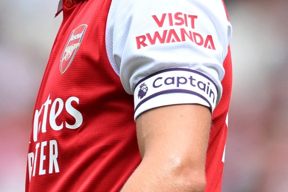 The Visit Rwanda logo is seen on the sleeve of Arsenal's Norwegian midfielder Martin Odegaard during a club-friendly football match between Arsenal and Sevilla at the Emirates Stadium in London on July 30, 2022. (Photo by JUSTIN TALLIS/AFP via Getty Images)