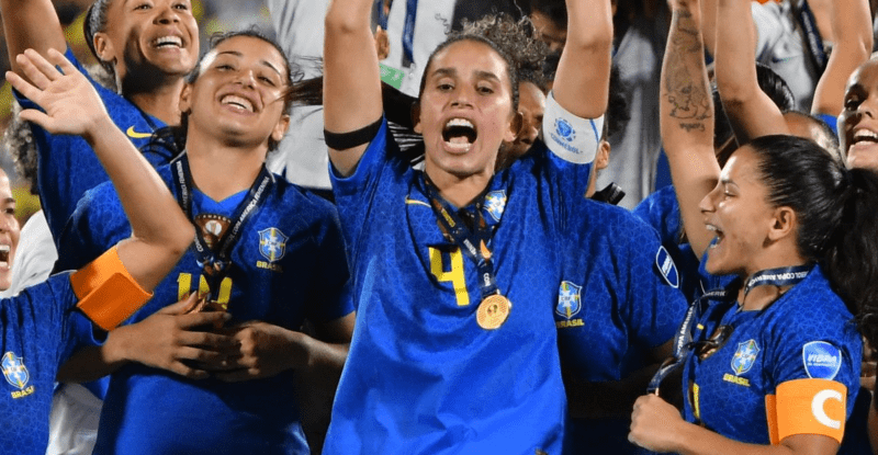 BUCARAMANGA, COLOMBIA - JULY 30: Rafaelle of Brazil lifts the trophy with teammates after winning the final match between Brazil and Colombia as part of Women's CONMEBOL Copa America 2022 at Estadio Alfonso Lopez on July 30, 2022 in Bucaramanga, Colombia. (Photo by Gabriel Aponte/Getty Images)