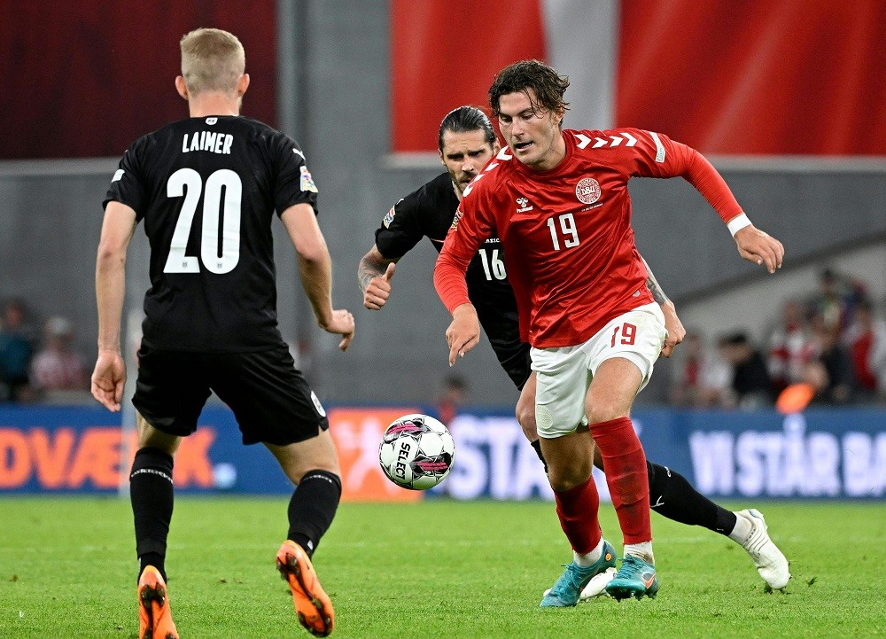 Austria's defender Christopher Trimmel (C), Konrad Laimer, and Denmark forward Jonas Wind (R) vie for the ball during the UEFA Nations League on June 13, 2022. (Photo by ROBERT JAEGER/APA/AFP via Getty Images)