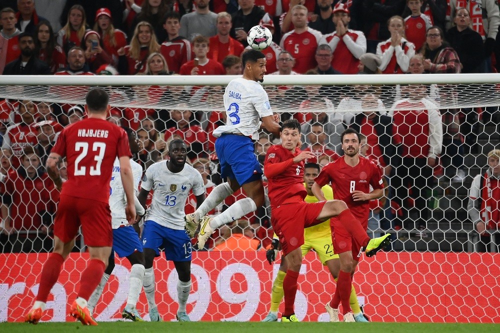 France's defender William Saliba (C) gets up to head the ball during the UEFA Nations League football match between Denmark and France in Copenhagen on September 25, 2022. (Photo by FRANCK FIFE/AFP via Getty Images)