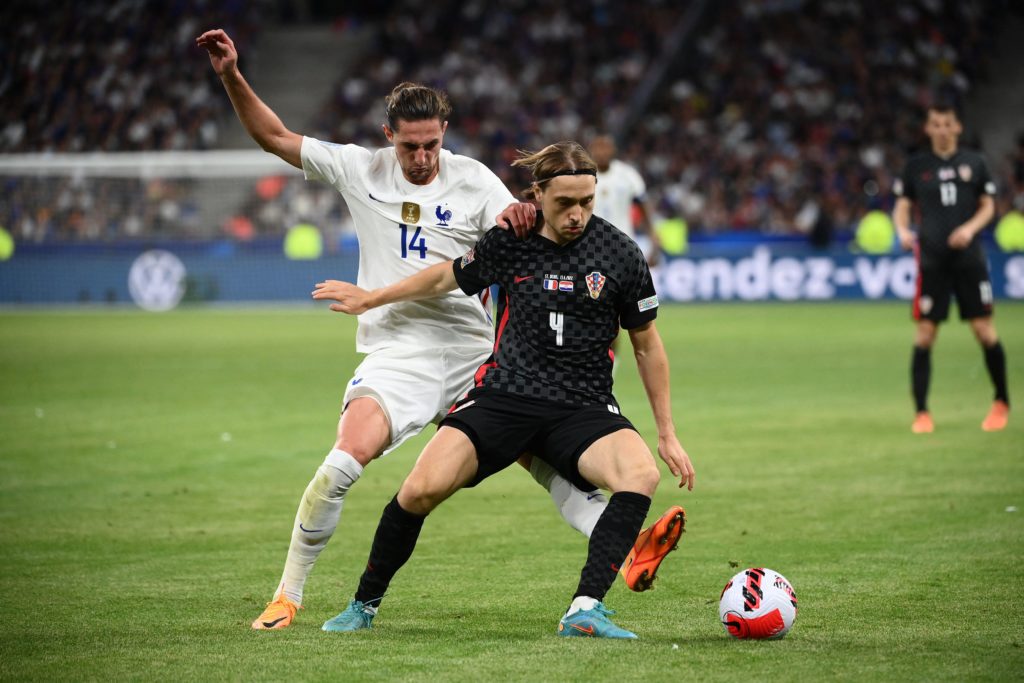 France's midfielder Adrien Rabiot (L) fights for the ball with Croatia's midfielder Lovro Majer (R) during the UEFA Nations League - League A Group 1 football match between France and Croatia at the Stade de France in Saint-Denis, on the outskirts of Paris on June 13, 2022. (Photo by FRANCK FIFE/AFP via Getty Images)