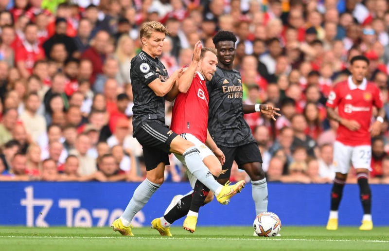 MANCHESTER, ENGLAND - SEPTEMBER 04: Christian Eriksen of Manchester United is fouled by Martin Oedegaard of Arsenal during the Premier League match between Manchester United and Arsenal FC at Old Trafford on September 04, 2022 in Manchester, England. (Photo by Michael Regan/Getty Images)