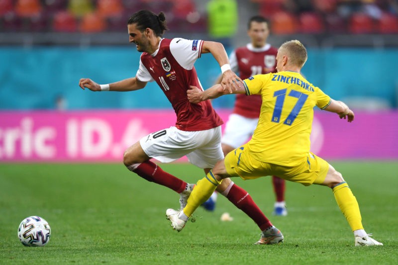 BUCHAREST, ROMANIA - JUNE 21: Florian Grillitsch of Austria runs with the ball whilst under pressure from Oleksandr Zinchenko of Ukraine during the UEFA Euro 2020 Championship Group C match between Ukraine and Austria at National Arena on June 21, 2021 in Bucharest, Romania. (Photo by Daniel Mihailescu - Pool/Getty Images)