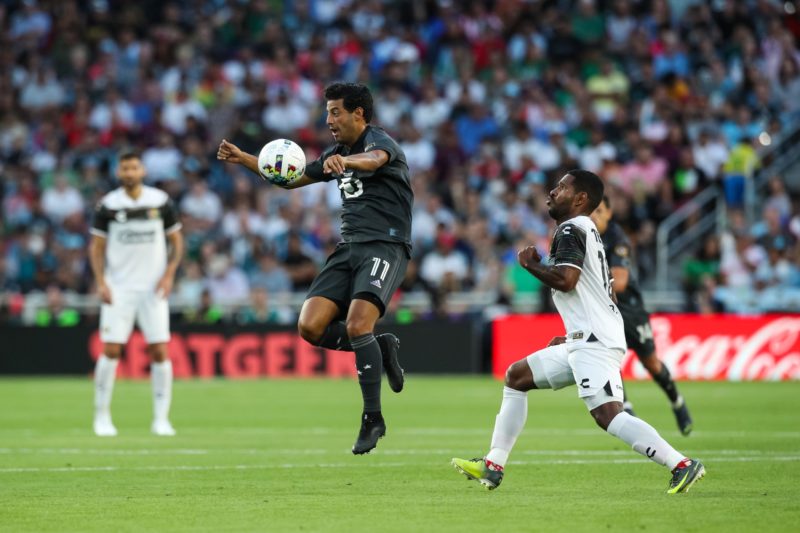 ST PAUL, MN - AUGUST 10: Carlos Vela #11 of the MLS All-Stars plays the ball ahead of Brayan Angulo #16 of the Liga MX All-Stars in the first half of the MLS All-Star game at Allianz Field on August 10, 2022 in St Paul, Minnesota. (Photo by David Berding/Getty Images)