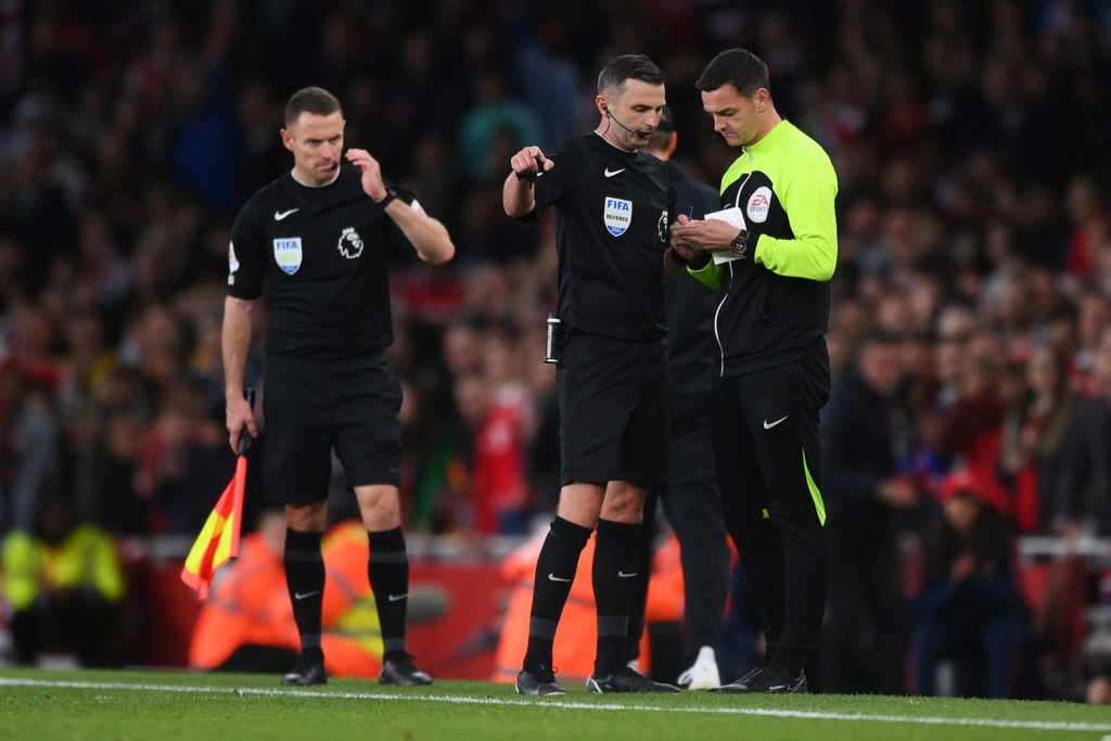 LONDON, ENGLAND - OCTOBER 09: Referee Michael Oliver speaks to fourth official Andy Madley during the Premier League match between Arsenal FC and Liverpool FC at Emirates Stadium on October 09, 2022 in London, England. (Photo by Shaun Botterill/Getty Images)