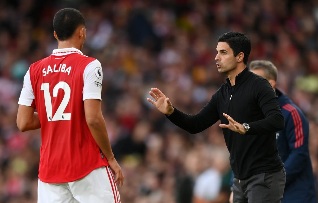 LONDON, ENGLAND - OCTOBER 09: Mikel Arteta speaks to William Saliba of Arsenal during the Premier League match between Arsenal FC and Liverpool FC at Emirates Stadium on October 09, 2022 in London, England. (Photo by Shaun Botterill/Getty Images)