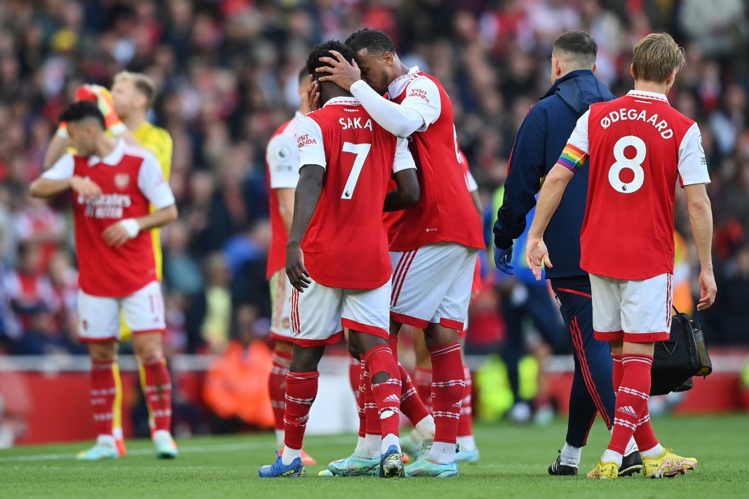 LONDON, ENGLAND - OCTOBER 30: Bukayo Saka of Arsenal is consoled by Gabriel Magalhaes after receiving medical treatment while leaving the pitch during the Premier League match between Arsenal FC and Nottingham Forest at Emirates Stadium on October 30, 2022 in London, England. (Photo by Justin Setterfield/Getty Images)