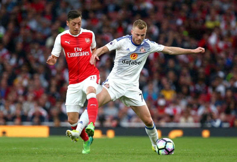 LONDON, ENGLAND - MAY 16: Mesut Ozil of Arsenal and Sebastian Larsson of Sunderland battle for possession during the Premier League match between Arsenal and Sunderland at Emirates Stadium on May 16, 2017 in London, England. (Photo by Charlie Crowhurst/Getty Images)