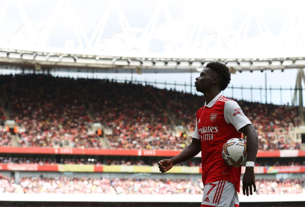 Arsenal's English midfielder Bukayo Saka holds the ball during the English Premier League football match between Arsenal and Tottenham Hotspur at the Emirates Stadium in London on October 1, 2022. (Photo by ADRIAN DENNIS/AFP via Getty Images)