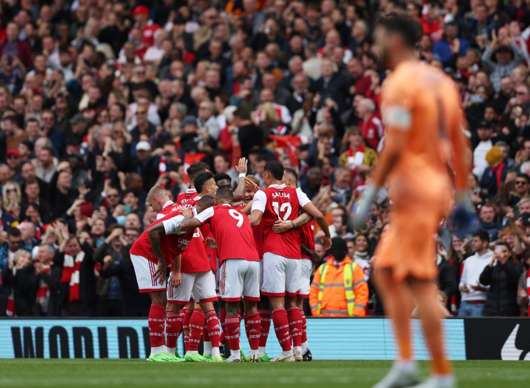 Arsenal players celebrate after Tottenham Hotspur's French goalkeeper Hugo Lloris failed to save a shot from Arsenal's Ghanaian midfielder Thomas Partey during the English Premier League football match between Arsenal and Tottenham Hotspur at the Emirates Stadium in London on October 1, 2022. (Photo by ADRIAN DENNIS/AFP via Getty Images)