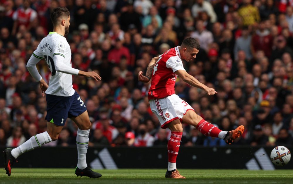 Arsenal's Swiss midfielder Granit Xhaka (R) shoots during the English Premier League football match between Arsenal and Tottenham Hotspur at the Emirates Stadium in London on October 1, 2022. (Photo by ADRIAN DENNIS/AFP via Getty Images)