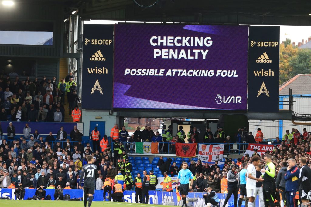 The big screen shows the reason VAR (Video Assistant Referee) are checking a possible Leeds penalty late in the game, overturned by English referee Chris Kavanagh during the English Premier League football match between Leeds United and Arsenal at Elland Road in Leeds, northern England on October 16, 2022. (Photo by LINDSEY PARNABY/AFP via Getty Images)