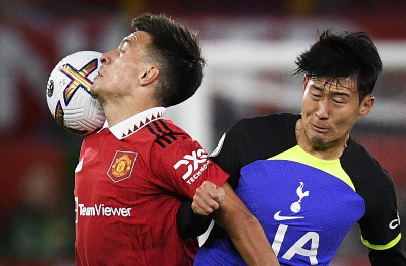 Manchester United's Argentinian defender Lisandro Martinez (L) heads the ball as he fights for it with Tottenham Hotspur's South Korean striker Son Heung-Min (R) during the English Premier League football match between Manchester United and Tottenham Hotspur at Old Trafford in Manchester, north west England, on October 19, 2022. (Photo by OLI SCARFF/AFP via Getty Images)