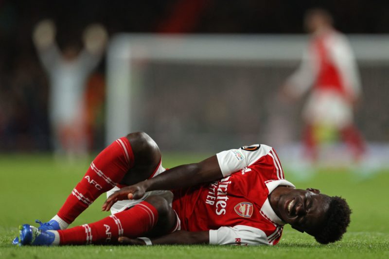 Arsenal's English midfielder Bukayo Saka reacts after appearing to pick up an injury during the UEFA Europa League Group A football match between Arsenal and PSV Eindhoven at The Arsenal Stadium in London, on October 20, 2022. (Photo by ADRIAN DENNIS/AFP via Getty Images)