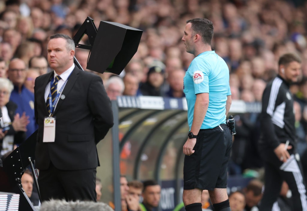 LEEDS, ENGLAND - OCTOBER 16: Referee Chris Kavanagh checks the VAR screen before giving a penalty to Leeds United during the Premier League match between Leeds United and Arsenal FC at Elland Road on October 16, 2022 in Leeds, England. (Photo by Alex Pantling/Getty Images)