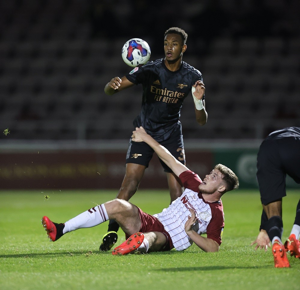NORTHAMPTON, ENGLAND: Zach Awe of Arsenal U21 looks to head the ball away from a grounded Jack Connor of Northampton Town during the Papa John's Trophy match between Northampton Town and Arsenal U21 at Sixfields on October 18, 2022. (Photo by Pete Norton/Getty Images)