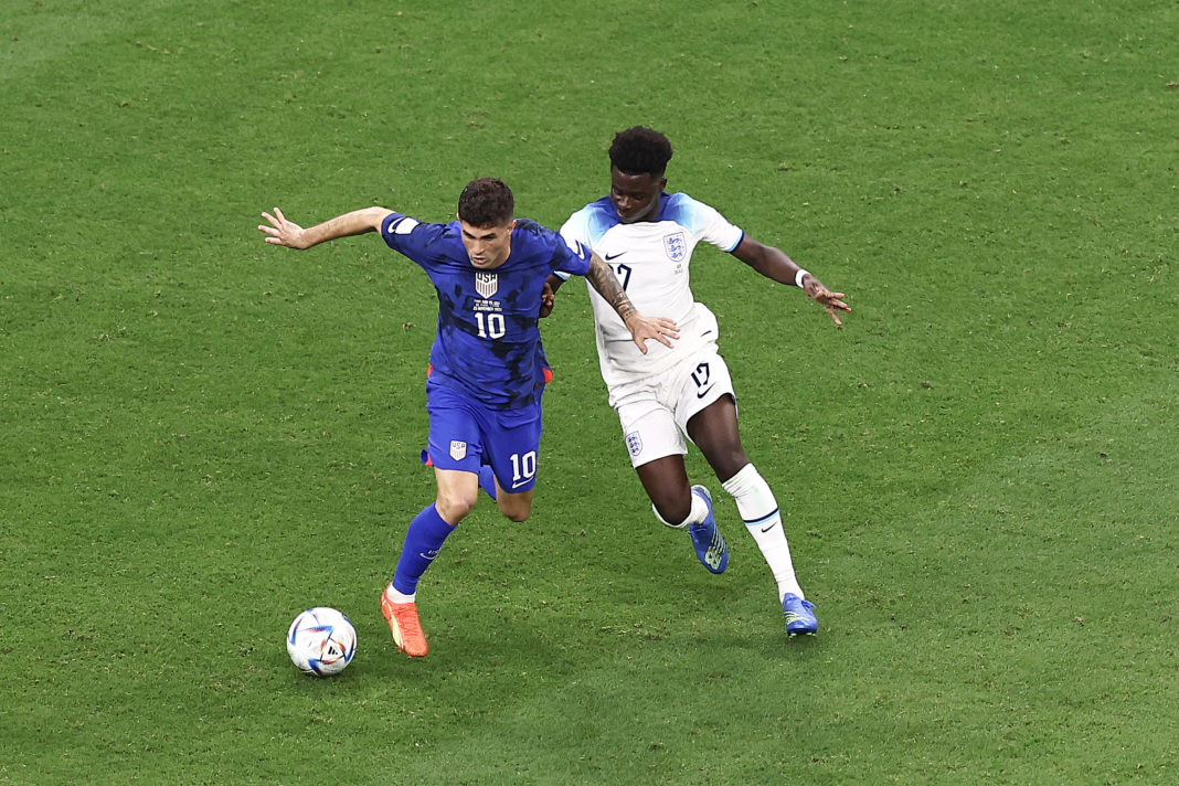 AL KHOR, QATAR: Christian Pulisic of the United States is challenged by Bukayo Saka of England during the FIFA World Cup Qatar 2022 Group B match between England and USA at Al Bayt Stadium on November 25, 2022. (Photo by Tim Nwachukwu/Getty Images)