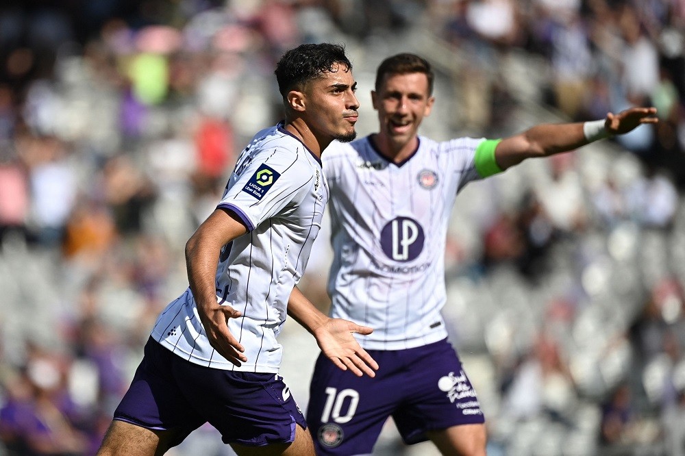Toulouse midfielder Fares Chaibi (L) celebrates scoring his team's third goal during the French L1 football match between Toulouse FC and Montpellier Herault SC at Stadium TFC in Toulouse, southwestern France, on October 2, 2022. (Photo by LIONEL BONAVENTURE/AFP via Getty Images)