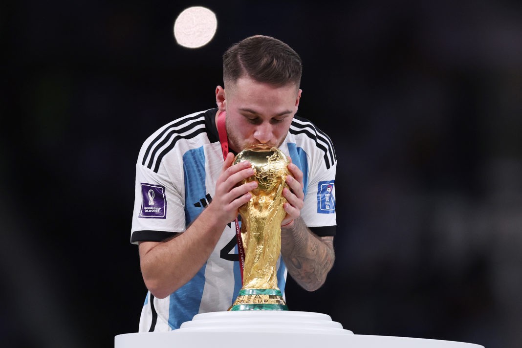 LUSAIL CITY, QATAR: Alexis Mac Allister of Argentina kisses the FIFA World Cup Qatar 2022 Winner's Trophy during the FIFA World Cup Qatar 2022 Final match between Argentina and France at Lusail Stadium on December 18, 2022. (Photo by Clive Brunskill/Getty Images)