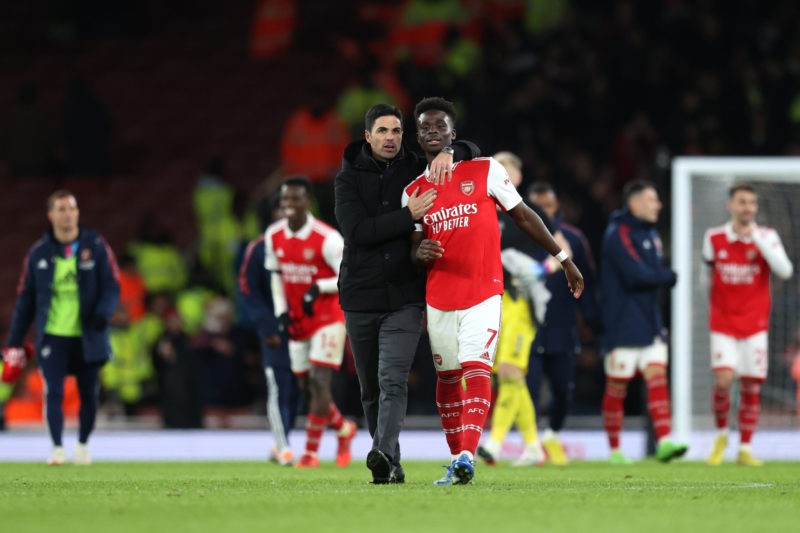 LONDON, ENGLAND - DECEMBER 26: Mikel Arteta, Manager of Arsenal embraces Bukayo Saka of Arsenal following the Premier League match between Arsenal FC and West Ham United at Emirates Stadium on December 26, 2022 in London, England. (Photo by Alex Pantling/Getty Images)