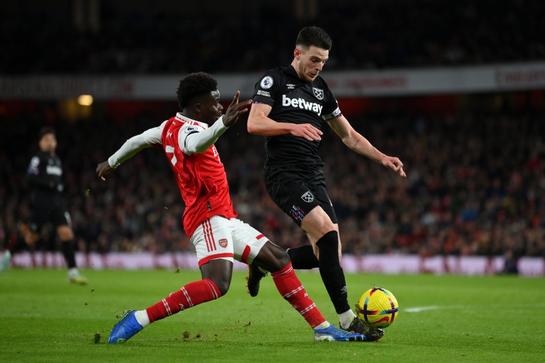 LONDON, ENGLAND - DECEMBER 26: Bukayo Saka of Arsenal tackles Declan Rice of West Ham United during the Premier League match between Arsenal FC and West Ham United at Emirates Stadium on December 26, 2022 in London, England. (Photo by Justin Setterfield/Getty Images)