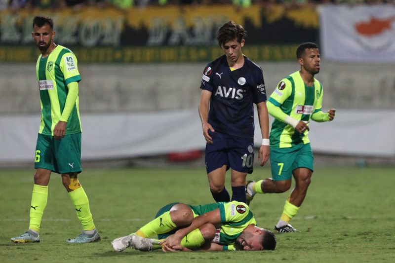 Fenerbahce's Turkish midfielder Arda Guler (C, top) checks on AEK Larnaca's Israeli forward Omri Altman (C, bottom) after a foul during the UEFA Europa League group B football match between Cyprus' AEK Larnaca and Turkey's Fenerbahce at the AEK Arena in the southern Cypriot city of Larnaca on October 13, 2022. (Photo by CHRISTINA ASSI/AFP via Getty Images)