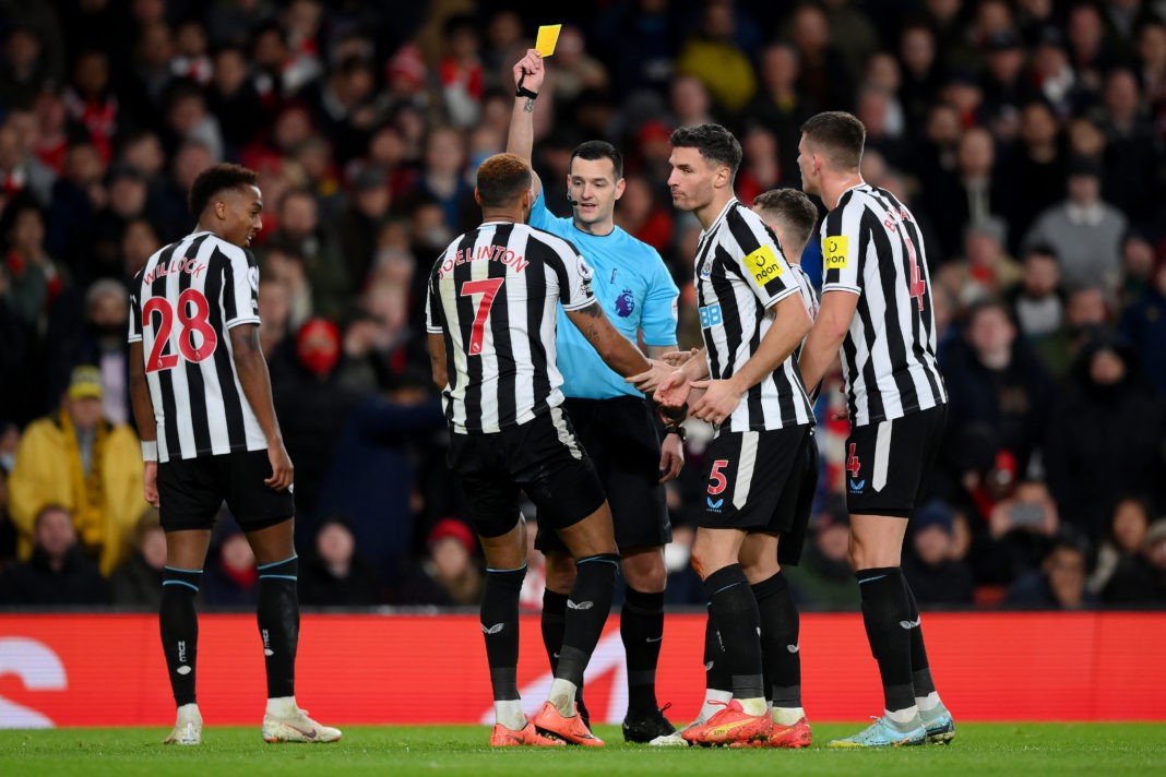 LONDON, ENGLAND - JANUARY 03: Referee Andy Madley shows a yellow card to Joelinton of Newcastle United during the Premier League match between Arsenal FC and Newcastle United at Emirates Stadium on January 03, 2023 in London, England. (Photo by Justin Setterfield/Getty Images)
