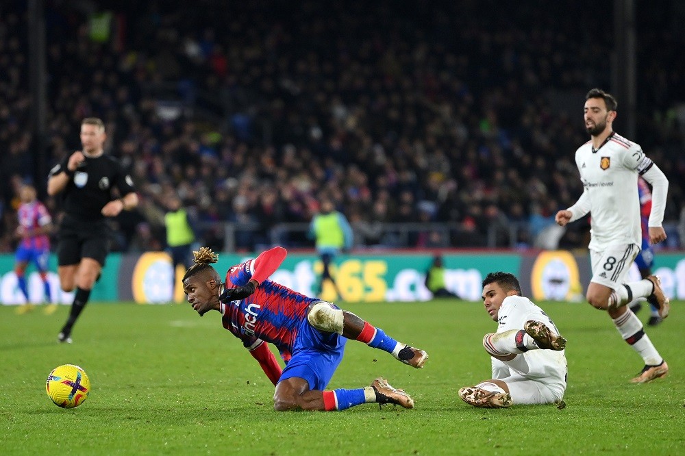 LONDON, ENGLAND: Casemiro of Manchester United fouls Wilfried Zaha of Crystal Palace leading to a yellow card during the Premier League match between Crystal Palace and Manchester United at Selhurst Park on January 18, 2023. (Photo by Justin Setterfield/Getty Images)