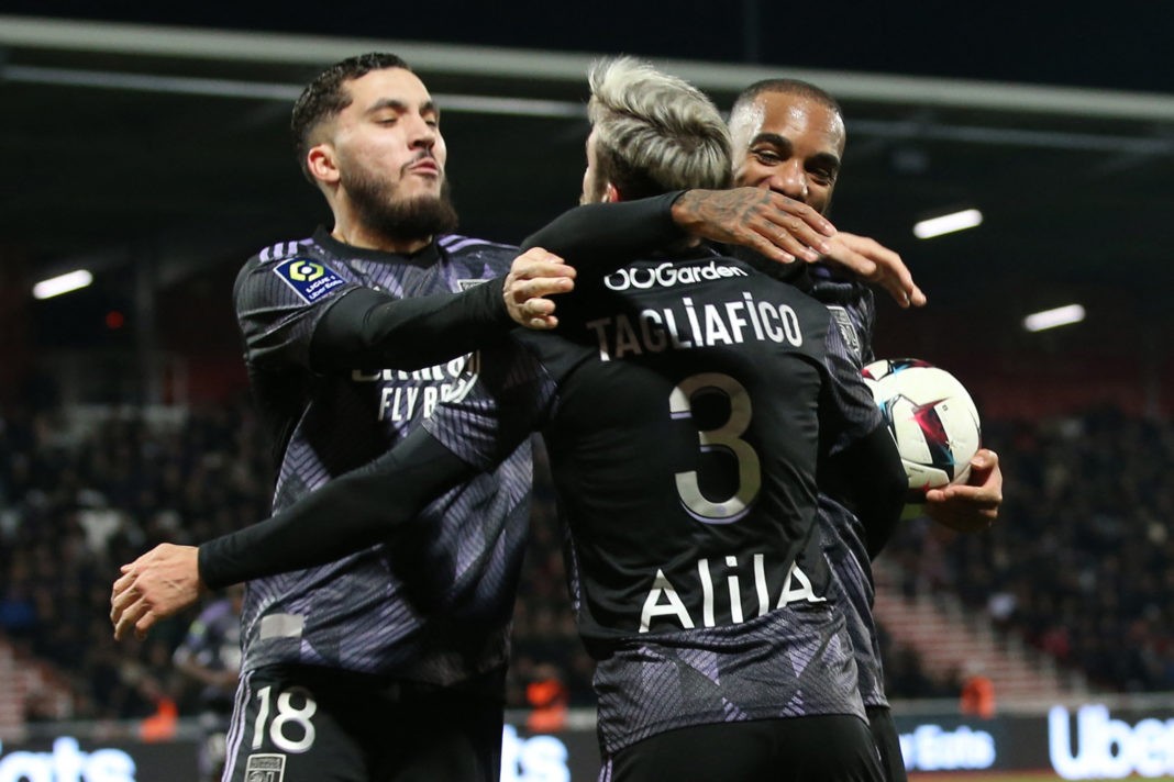 Lyon's French forward Alexandre Lacazette (R) is congratulated by teammates after scoring a goal during the L1 Football match Ajaccio vs Lyon at the François Coty Stadium in Ajaccio on January 29, 2023. (Photo by PASCAL POCHARD-CASABIANCA/AFP via Getty Images)
