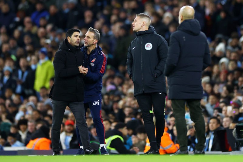 MANCHESTER, ENGLAND - JANUARY 27: Mikel Arteta, Manager of Arsenal, is held back by Albert Stuivenberg, Assistant Manager of Arsenal, as they speak with the fourth official during the Emirates FA Cup Fourth Round match between Manchester City and Arsenal at Etihad Stadium on January 27, 2023 in Manchester, England. (Photo by Michael Steele/Getty Images)