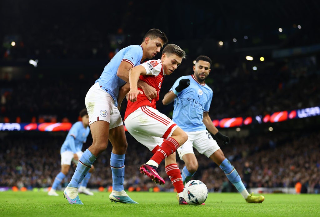 MANCHESTER, ENGLAND - JANUARY 27: Leandro Trossard of Arsenal is challenged by Joao Cancelo and Riyad Mahrez of Manchester City during the Emirates FA Cup Fourth Round match between Manchester City and Arsenal at Etihad Stadium on January 27, 2023 in Manchester, England. (Photo by Michael Steele/Getty Images)