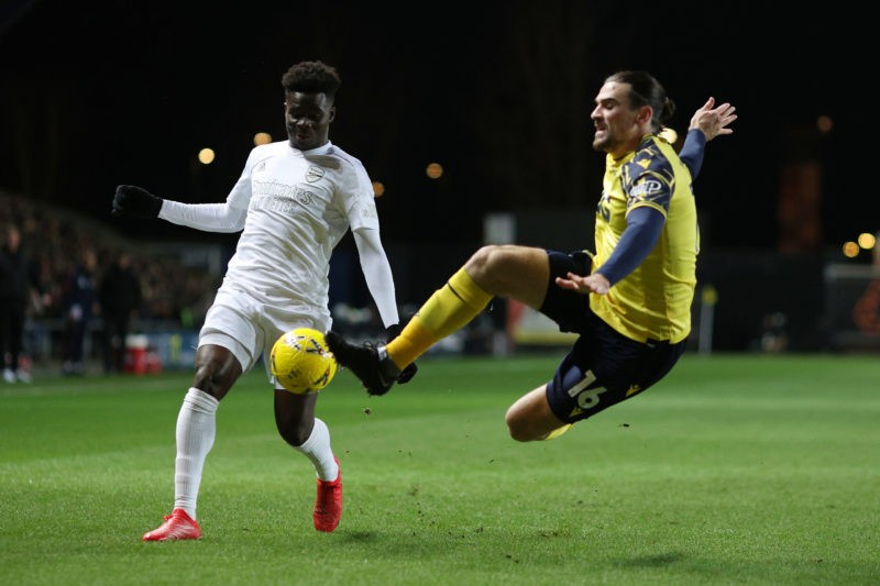 OXFORD, ENGLAND - JANUARY 09: Ciaron Brown of Oxford United clears a shot from Bukayo Saka of Arsenal during the Emirates FA Cup Third Round match between Oxford United and Arsenal at Kassam Stadium on January 09, 2023 in Oxford, England. (Photo by Richard Heathcote/Getty Images)