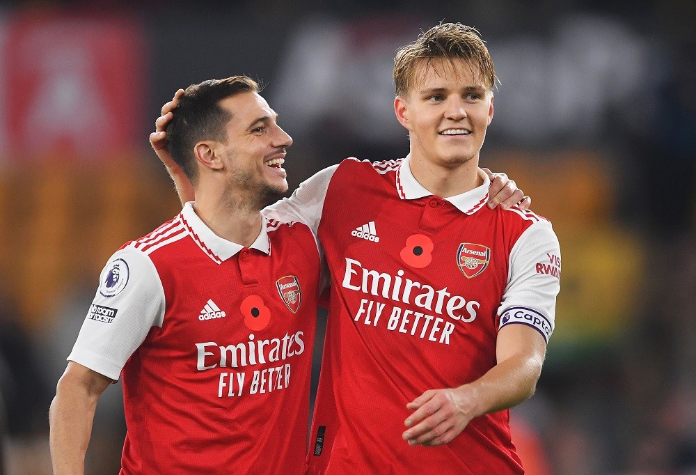 WOLVERHAMPTON, ENGLAND: Cedric Soares and Martin Oedegaard of Arsenal celebrates following their side's victory in the Premier League match between Wolverhampton Wanderers and Arsenal FC at Molineux on November 12, 2022. (Photo by Harriet Lander/Getty Images)