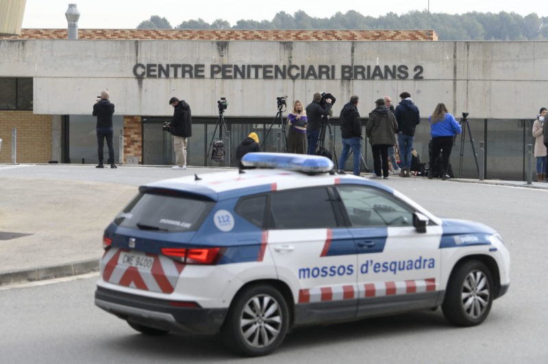 A police car is seen next to journalists informing outside the prison in San Esteve Sesrovires, 40 km from Barcelona, where Brazilian football player Dani Alves is jailed, on February 21, 2023. - Former Barcelona defender Dani Alves will remain in preventative custody pending his trial for alleged rape as he is considered a high flight risk, the Provincial Court of Barcelona decided today. (Photo by Josep LAGO / AFP) (Photo by JOSEP LAGO/AFP via Getty Images)