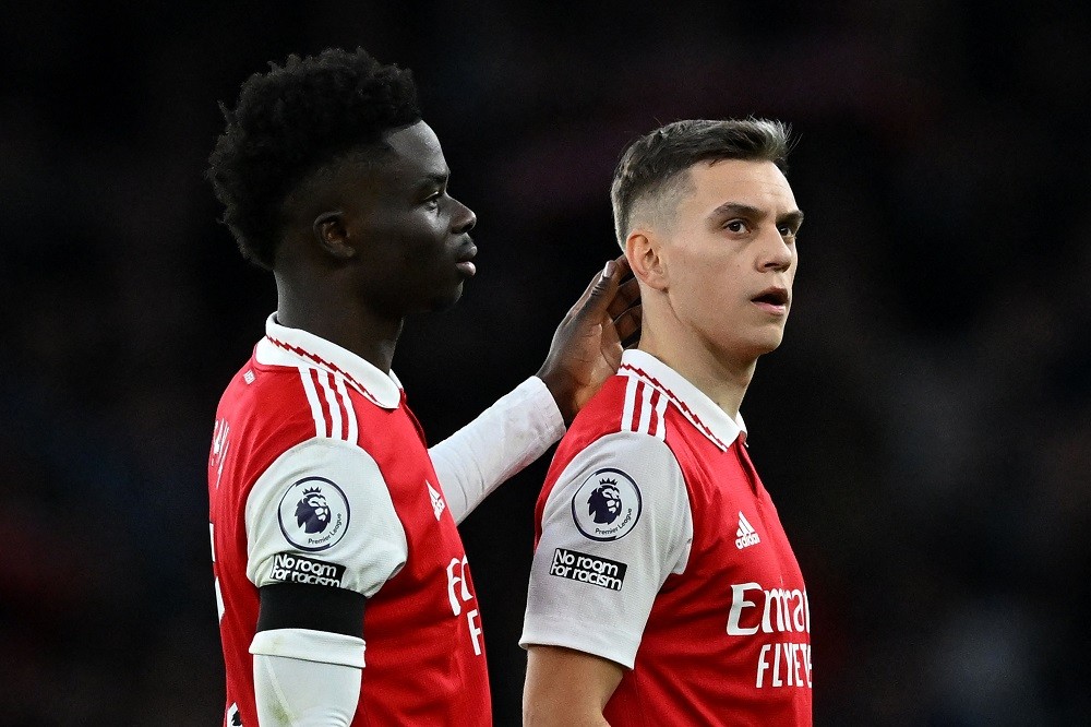 Arsenal's English midfielder Bukayo Saka (L) and Arsenal's Belgian midfielder Leandro Trossard react after the English Premier League football match between Arsenal and Brentford at the Emirates Stadium in London on February 11, 2023. (Photo by JUSTIN TALLIS/AFP via Getty Images)