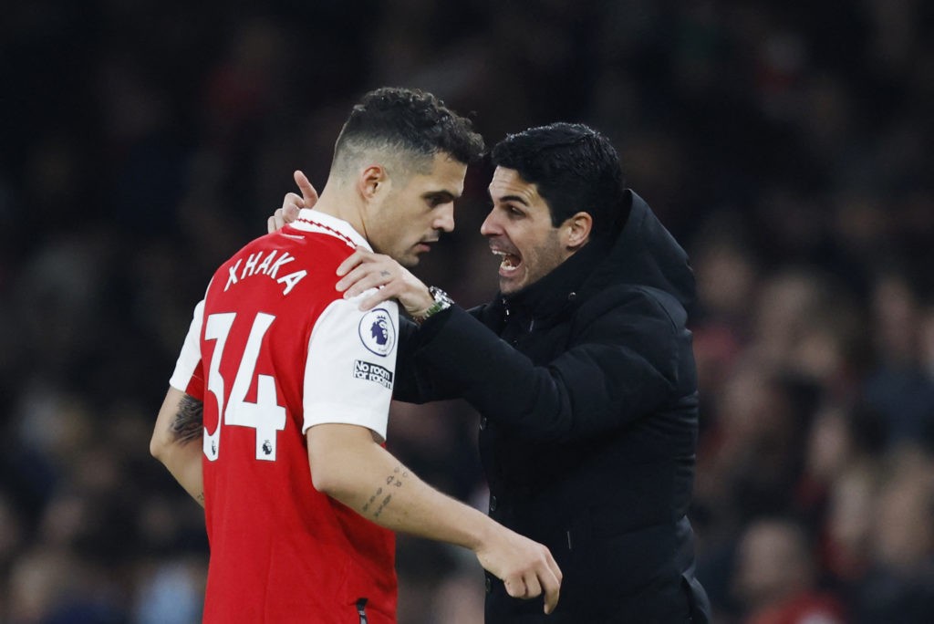 Arsenal's Spanish manager Mikel Arteta (R) speaks to Arsenal's Swiss midfielder Granit Xhaka during the English Premier League football match between Arsenal and Manchester City at the Emirates Stadium in London on February 15, 2023. (Photo by IAN KINGTON/IKIMAGES/AFP via Getty Images)