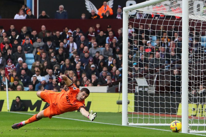 Aston Villa's Argentinian goalkeeper Emiliano Martinez dives but is unable to stop a shot from Arsenal's Ukrainian defender Oleksandr Zinchenko making it 2-2 during the English Premier League football match between Aston Villa and Arsenal at Villa Park in Birmingham, central England on February 18, 2023. (Photo by GEOFF CADDICK/AFP via Getty Images)