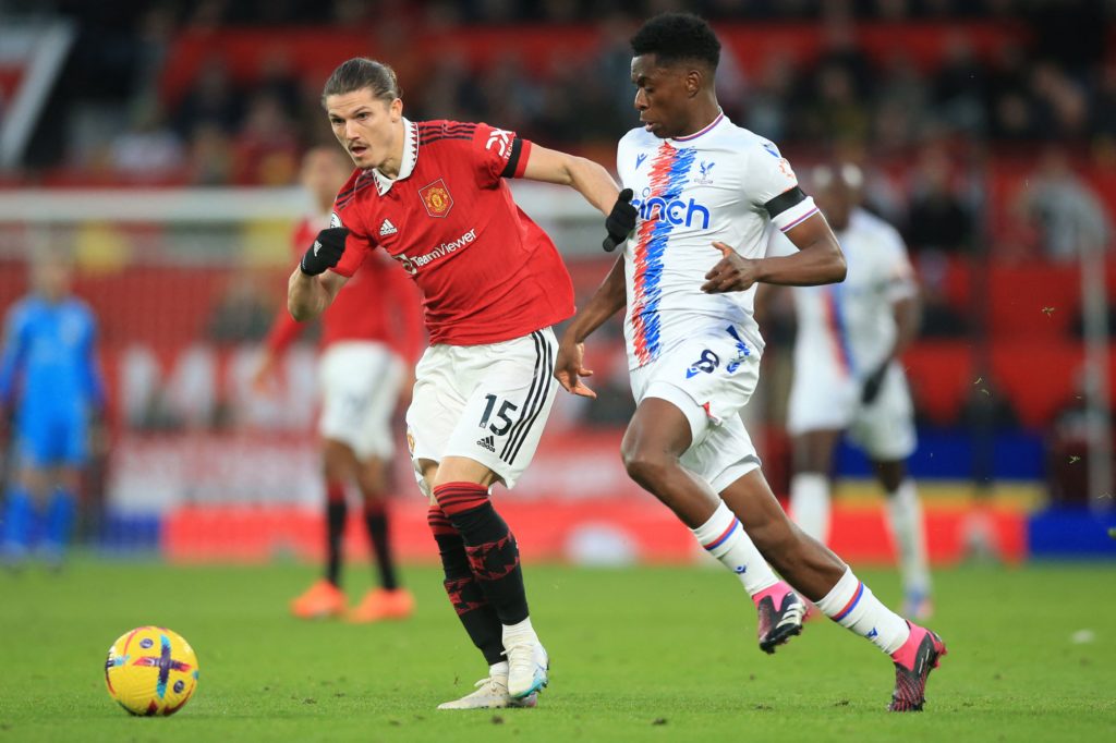 Manchester United's Austrian midfielder Marcel Sabitzer (L) challenges Crystal Palace's Belgian midfielder Albert Sambi Lokonga (R) during the English Premier League football match between Manchester United and Crystal Palace at Old Trafford in Manchester, north-west England, on February 4, 2023. (Photo by LINDSEY PARNABY/AFP via Getty Images)