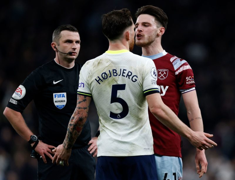 Referee Michael Oliver (L) reacts as Tottenham Hotspur's Danish midfielder Pierre-Emile Hojbjerg (C) remonstrates with West Ham United's English midfielder Declan Rice during the English Premier League football match between Tottenham Hotspur and West Ham United at Tottenham Hotspur Stadium in London, on February 19, 2023. (Photo by IAN KINGTON/AFP via Getty Images)